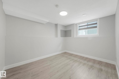 Spare room with baseboards and light wood-type flooring - 2919 151A Avenue, Edmonton, AB - Indoor Photo Showing Other Room