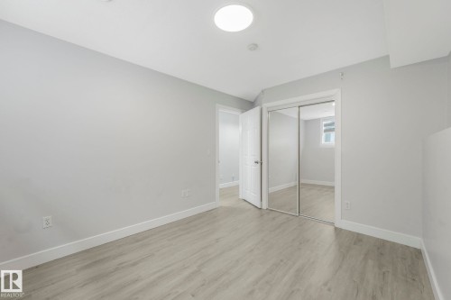 Unfurnished bedroom with a closet and light wood-style flooring - 2919 151A Avenue, Edmonton, AB - Indoor Photo Showing Other Room