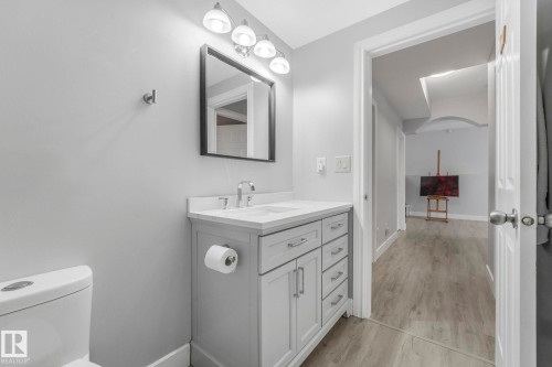 Bathroom with vanity and light wood-style flooring - 2919 151A Avenue, Edmonton, AB - Indoor Photo Showing Bathroom
