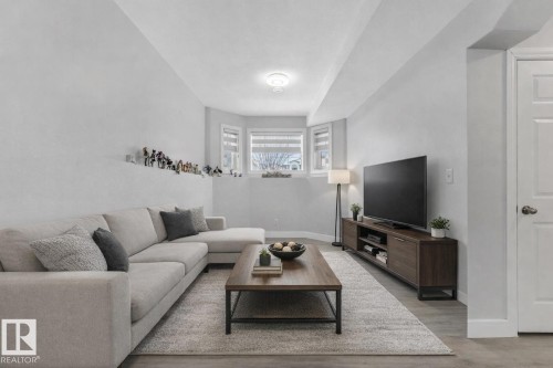 Family room with baseboards and light wood-type flooring - 2919 151A Avenue, Edmonton, AB - Indoor Photo Showing Living Room