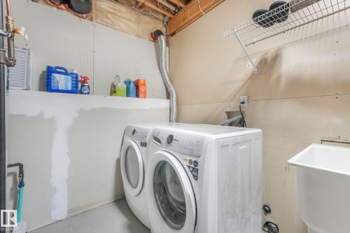 Laundry area featuring independent washer and dryer and finished concrete flooring - 2919 151A Avenue, Edmonton, AB - Indoor Photo Showing Laundry Room