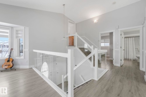 Stairs featuring wood finished floors and baseboards - 2919 151A Avenue, Edmonton, AB - Indoor Photo Showing Other Room