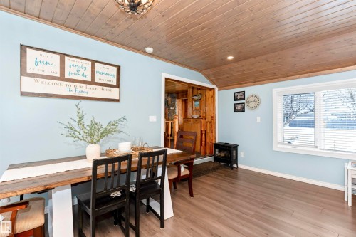 Dining room with plenty of natural light, wood ceiling, light wood-style floors, and suspended lighting - 516 5 Street, Rural Lac Ste. Anne County, AB - Indoor Photo Showing Dining Room