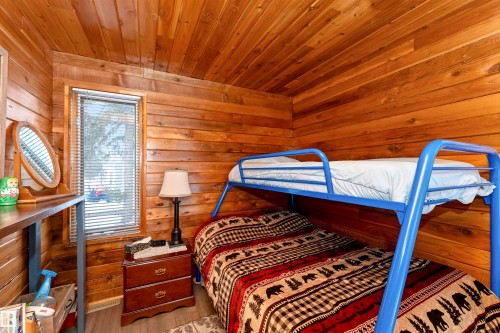 Bedroom with wood walls and wood ceiling - 516 5 Street, Rural Lac Ste. Anne County, AB - Indoor Photo Showing Bedroom