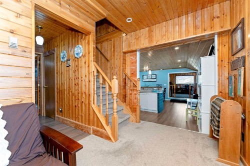 Living area with wooden ceiling, wood walls, and carpet - 516 5 Street, Rural Lac Ste. Anne County, AB - Indoor Photo Showing Other Room