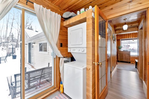 Dock area with boat lift, a water view, and a yard - 516 5 Street, Rural Lac Ste. Anne County, AB - Outdoor With Body Of Water With View