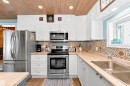 Kitchen featuring stainless steel appliances, white cabinets, wood ceiling, and recessed lighting - 516 5 Street, Rural Lac Ste. Anne County, AB  - Indoor Photo Showing Kitchen 