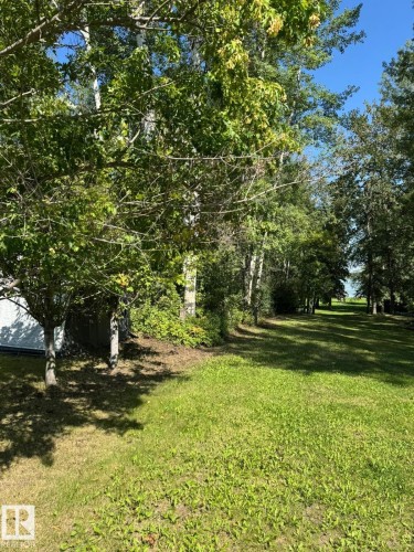 View of green lawn featuring a vegetable garden - 516 5 Street, Rural Lac Ste. Anne County, AB - Outdoor