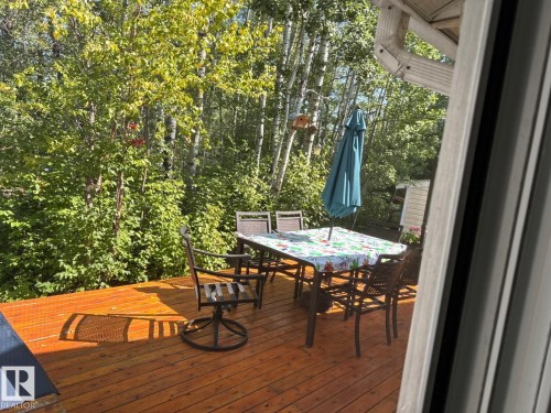 Rear view of property with a lawn and a deck - 516 5 Street, Rural Lac Ste. Anne County, AB - Outdoor