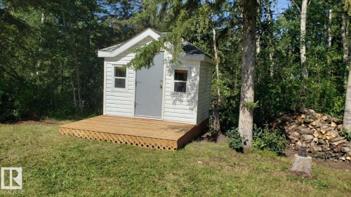 Rear view of house featuring a shingled roof and a wooden deck - 516 5 Street, Rural Lac Ste. Anne County, AB - Outdoor With Deck Patio Veranda With Exterior
