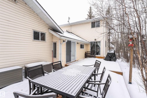 Snow covered patio featuring outdoor dining area and a wooden deck - 516 5 Street, Rural Lac Ste. Anne County, AB - Outdoor With Deck Patio Veranda With Exterior