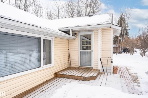 Snow covered property entrance featuring a deck - 516 5 Street, Rural Lac Ste. Anne County, AB - Outdoor With Deck Patio Veranda