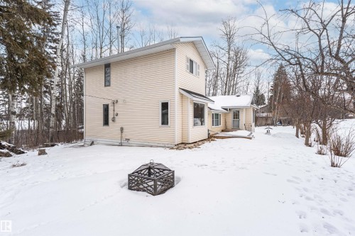 Snow covered back of property featuring an outdoor fire pit - 516 5 Street, Rural Lac Ste. Anne County, AB - Outdoor