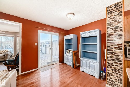 Interior space featuring a textured ceiling and light wood-style flooring - 2927 30 Street, Edmonton, AB - Indoor Photo Showing Other Room