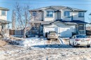 View of front of property featuring a shingled roof, driveway, a garage, and covered porch - 2927 30 Street, Edmonton, AB  - Outdoor 