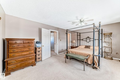 Bedroom with carpet floors, a textured ceiling, and ceiling fan - 2927 30 Street, Edmonton, AB - Indoor