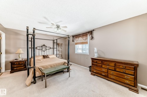 Bedroom with carpet floors, a textured ceiling, and a ceiling fan - 2927 30 Street, Edmonton, AB - Indoor Photo Showing Bedroom