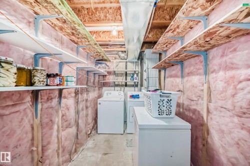 Laundry room featuring unfinished concrete flooring and washer and clothes dryer - 2927 30 Street, Edmonton, AB - Indoor Photo Showing Laundry Room