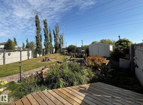 Wooden terrace featuring a fenced backyard, an outdoor fire pit, and a shed - 2927 30 Street, Edmonton, AB - Outdoor With Deck Patio Veranda