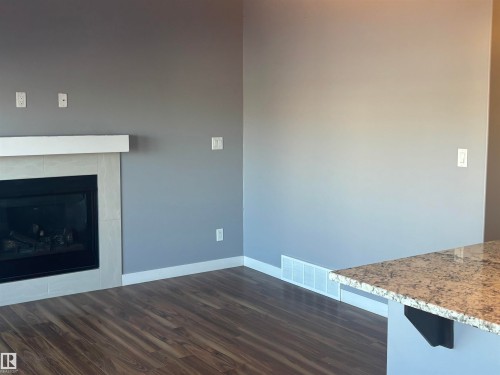 6694 Cardinal Road, Edmonton, AB - Indoor Photo Showing Living Room With Fireplace