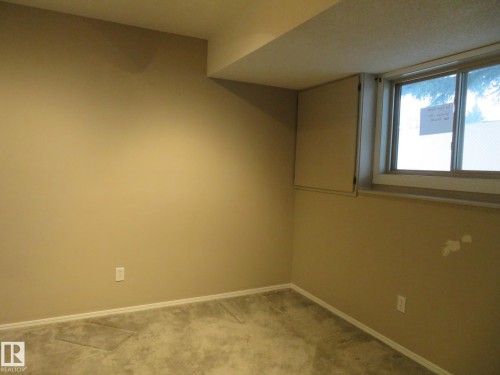 Empty room with baseboards and light colored carpet - 1855 Mill Woods Road E, Edmonton, AB - Indoor Photo Showing Other Room