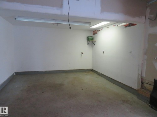 Garage with baseboards - 1855 Mill Woods Road E, Edmonton, AB - Indoor Photo Showing Garage