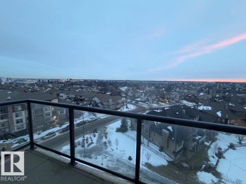 Snow covered back of property featuring a residential view - 706 5151 Windermere Bv, Edmonton, AB - Outdoor With View
