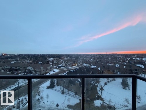 Balcony at dusk with a residential view - 706 5151 Windermere Bv, Edmonton, AB - Outdoor With View