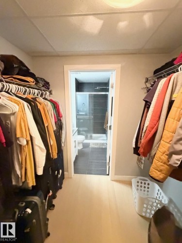 Walk in closet with a paneled ceiling - 706 5151 Windermere Bv, Edmonton, AB - Indoor With Storage