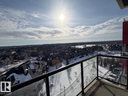Snow covered back of property featuring a residential view - 706 5151 Windermere Bv, Edmonton, AB - Outdoor With View