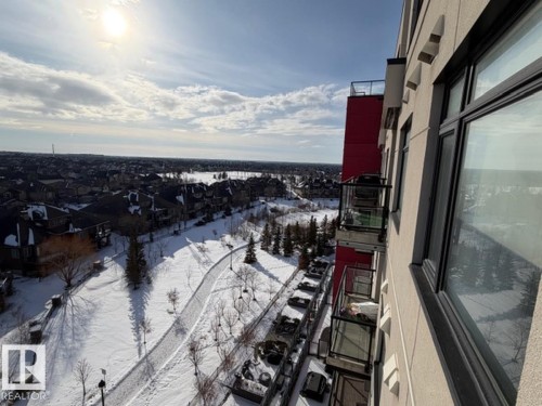 View of snow covered back of property - 706 5151 Windermere Bv, Edmonton, AB - Outdoor With View