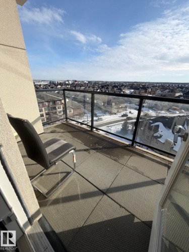 View of snow covered back of property - 706 5151 Windermere Bv, Edmonton, AB - Outdoor With View