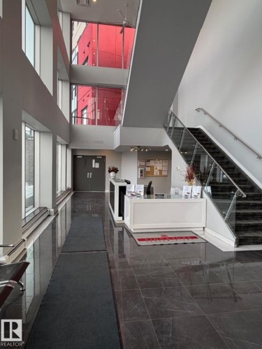 Reception area with stairs and a high ceiling - 706 5151 Windermere Bv, Edmonton, AB - Indoor Photo Showing Other Room