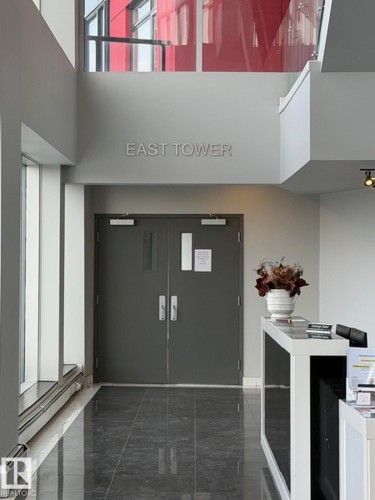 Entryway featuring a high ceiling and a baseboard radiator - 706 5151 Windermere Bv, Edmonton, AB -  Photo Showing Other Room