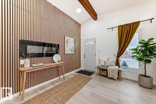 Foyer entrance with light wood-style flooring, recessed lighting, an accent wall, and vaulted ceiling with beams - 10519 173 Avenue, Edmonton, AB - Indoor Photo Showing Other Room