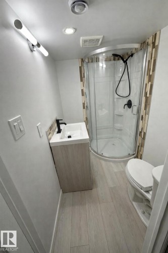 Full bathroom with vanity, a stall shower, and light wood finished floors - 10519 173 Avenue, Edmonton, AB - Indoor Photo Showing Bathroom
