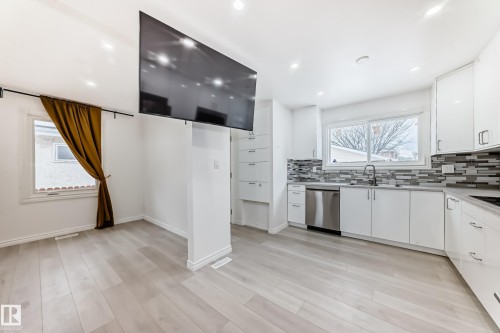 Kitchen with tasteful backsplash, white cabinetry, dishwasher, recessed lighting, and light wood-style floors - 10519 173 Avenue, Edmonton, AB - Indoor Photo Showing Kitchen With Double Sink With Upgraded Kitchen
