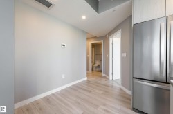 Kitchen with freestanding refrigerator, light wood-type flooring, and recessed lighting - 