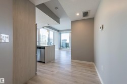 Hallway with light wood finished floors and a textured ceiling - 