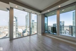 Livingroom with a city view, wood color floors, a textured ceiling, and recessed lighting - 