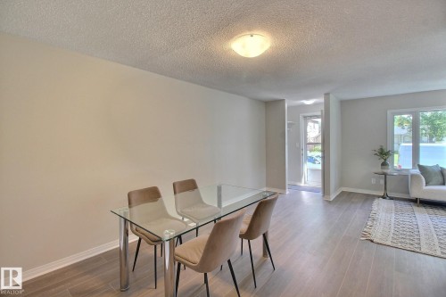 Dining area with vinyl plank  floors and a textured ceiling - 11512 67 Street, Edmonton, AB - Indoor