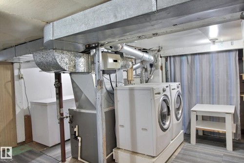 Laundry area featuring washing machine and clothes dryer and heating unit - 11512 67 Street, Edmonton, AB - Indoor Photo Showing Laundry Room