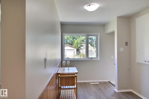 Entryway with vinyl plank  floors and baseboards - 11512 67 Street, Edmonton, AB - Indoor Photo Showing Other Room