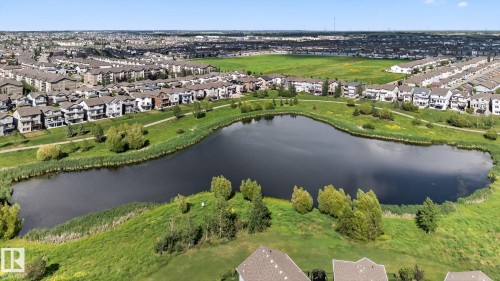 Aerial view of property and surrounding area with nearby suburban area and a large body of water - 209 3353 16A, Edmonton, AB - Outdoor With View