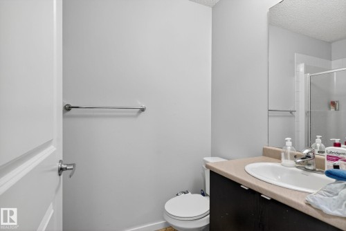 Bathroom with vanity, a textured ceiling, and a shower stall - 209 3353 16A, Edmonton, AB - Indoor Photo Showing Bathroom