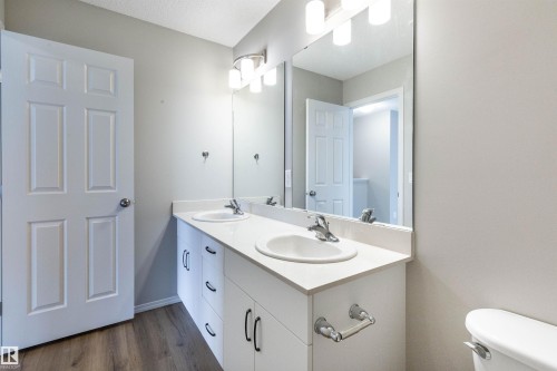 Bathroom with double vanity and dark wood-type flooring - 17259 9A Avenue Sw, Edmonton, AB - Indoor Photo Showing Bathroom