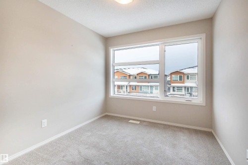 Spare room with light carpet and a textured ceiling - 17259 9A Avenue Sw, Edmonton, AB - Indoor Photo Showing Other Room