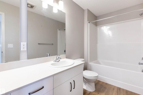 Full bath with vanity, bathtub / shower combination, and light wood-type flooring - 17259 9A Avenue Sw, Edmonton, AB - Indoor Photo Showing Bathroom