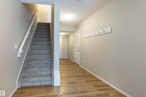 Stairs with wood finished floors and a textured ceiling - 17259 9A Avenue Sw, Edmonton, AB - Indoor Photo Showing Other Room