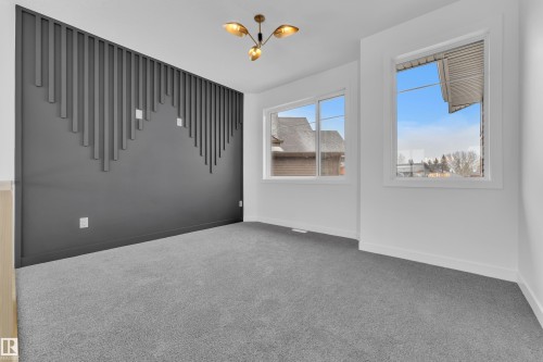 Empty room with carpet flooring and hanging lights - 159 Graybriar Dr, Stony Plain, AB - Indoor Photo Showing Other Room